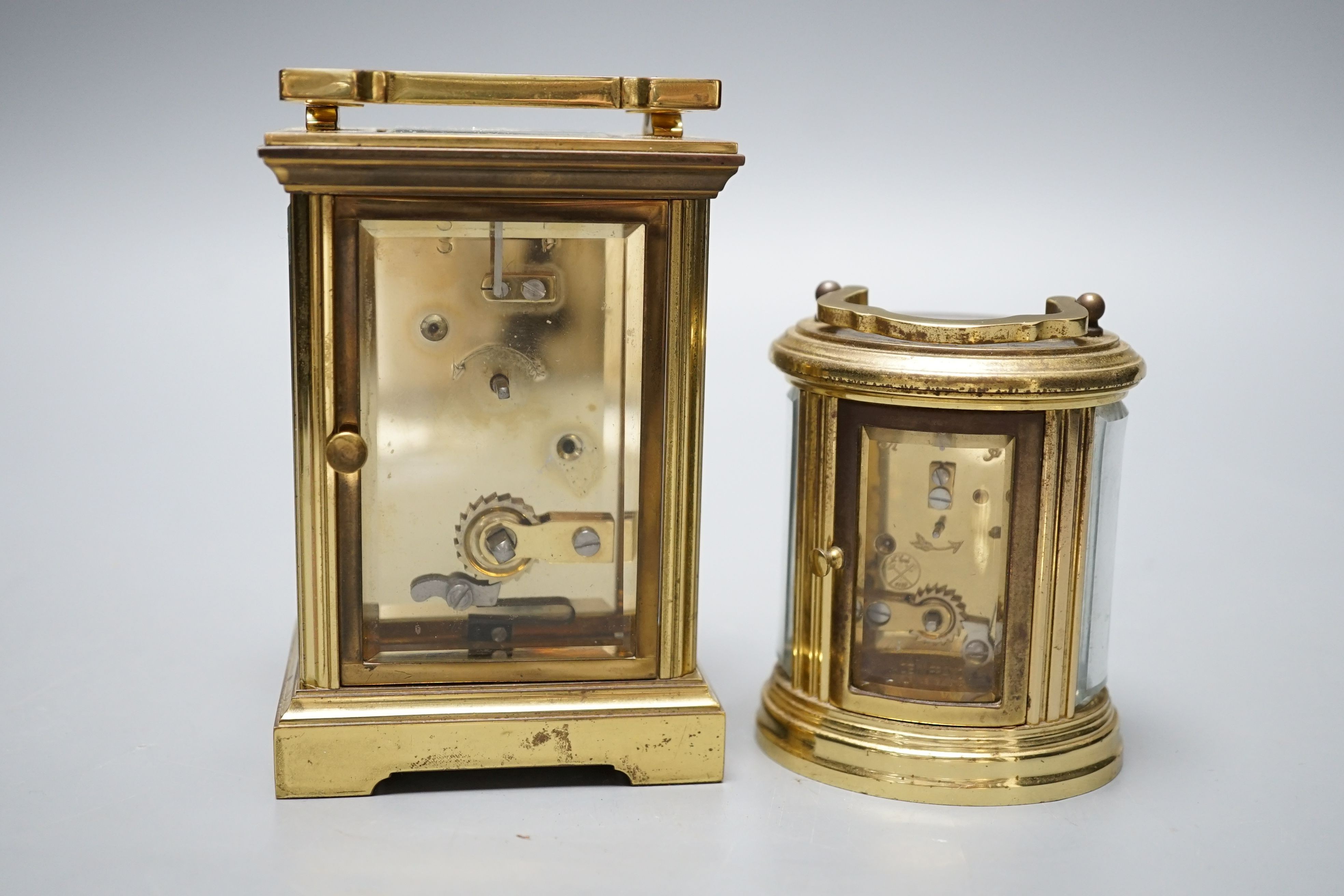 Two modern brass carriage timepieces, one oval cased